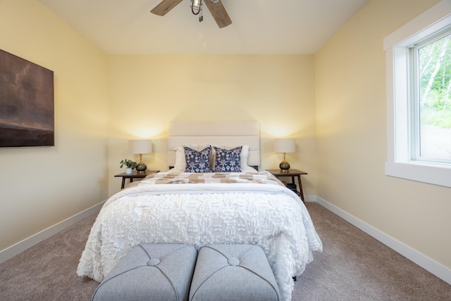 carpeted bedroom featuring baseboards and a ceiling fan