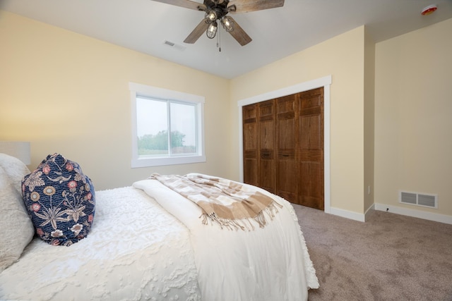 carpeted bedroom featuring a closet and ceiling fan