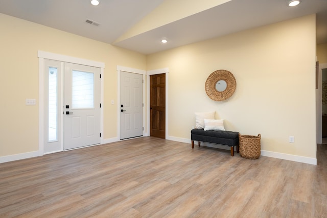 foyer entrance with vaulted ceiling, light wood-style floors, and recessed lighting