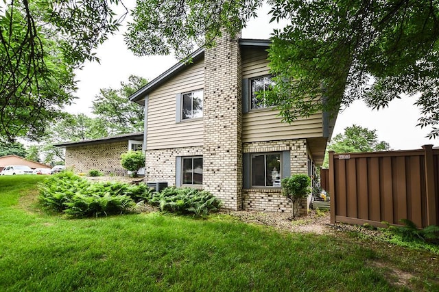 7097 Robinwood Bay, Woodbury, MN 55125 - rear view of property with a chimney and brick siding