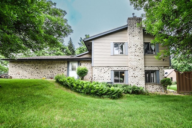 7097 Robinwood Bay, Woodbury, MN 55125 - rear view of property with brick siding, a yard, and a chimney