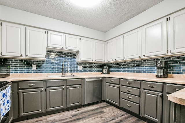 7097 Robinwood Bay, Woodbury, MN 55125 - kitchen featuring appliances with stainless steel finishes, gray cabinetry, white cabinetry, and a textured ceiling