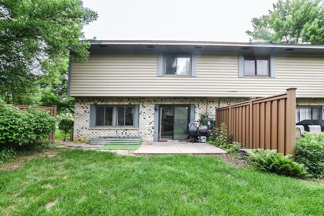 7097 Robinwood Bay, Woodbury, MN 55125 - back of house with brick siding, a lawn, and a patio