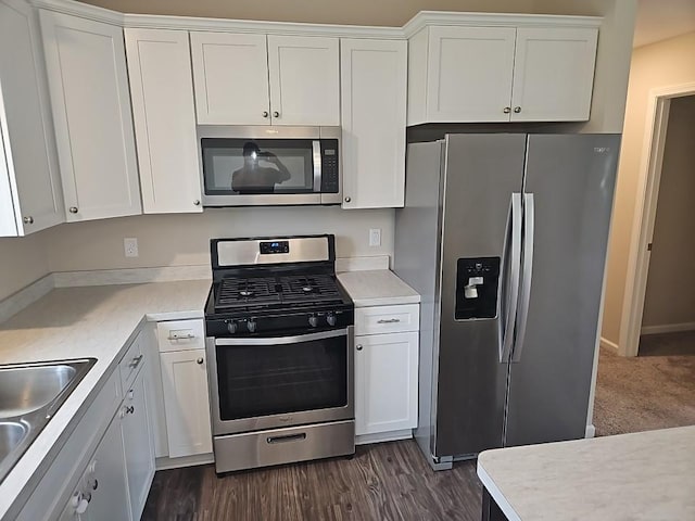 591 Alaska Loop, Cambridge, MN 55008 - kitchen with stainless steel appliances, white cabinets, light countertops, and dark wood-style floors