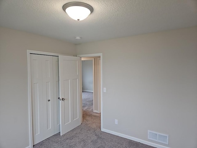 591 Alaska Loop, Cambridge, MN 55008 - unfurnished bedroom with carpet flooring, a textured ceiling, and a closet