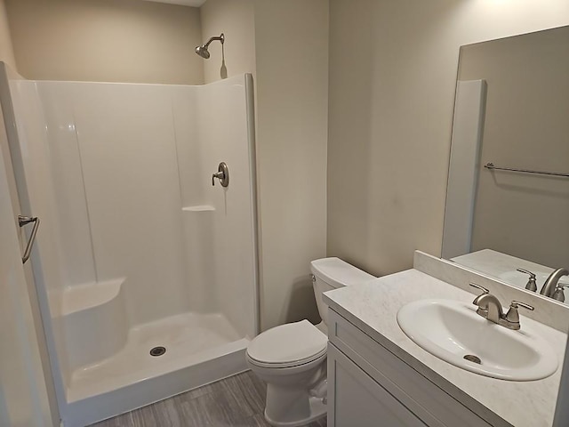 591 Alaska Loop, Cambridge, MN 55008 - bathroom with a walk in shower, vanity, and wood finished floors