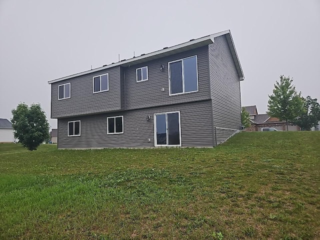 591 Alaska Loop, Cambridge, MN 55008 - rear view of house featuring a lawn
