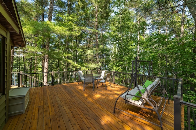 23148 Glenhaven Dr, Nevis, MN 56467 - deck featuring outdoor dining area and view of wooded area
