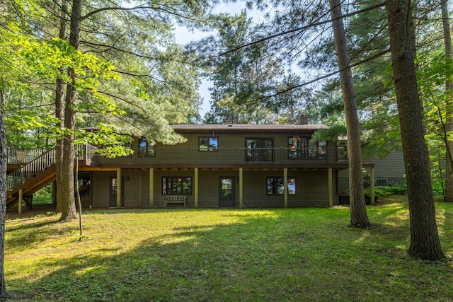 23148 Glenhaven Dr, Nevis, MN 56467 - rear view of house with stairs, a deck, a yard, and a chimney