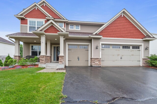 17393 54th St NE, Otsego, MN 55374 - craftsman-style home with stone siding, driveway, a front lawn, a garage, and a shingled roof