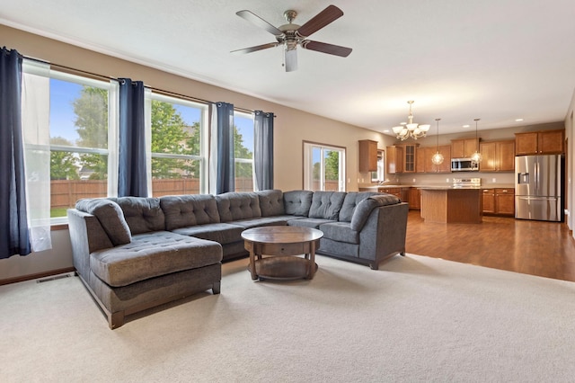 17393 54th St NE, Otsego, MN 55374 - living room featuring carpet, a chandelier, and ceiling fan