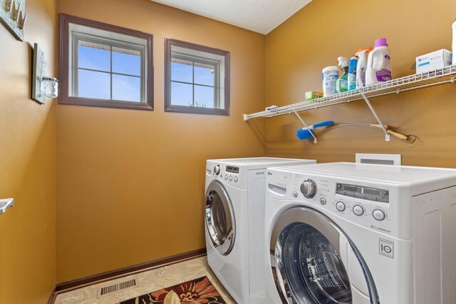 17393 54th St NE, Otsego, MN 55374 - laundry area featuring washer and dryer and light tile patterned flooring
