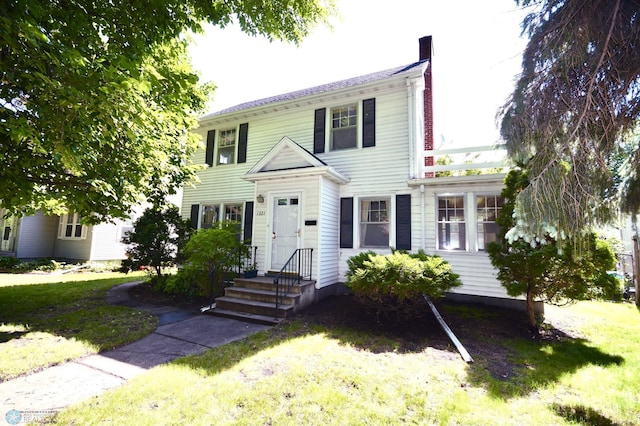 1321 4th St N, Fargo, ND 58102 - colonial house featuring a chimney and a front lawn