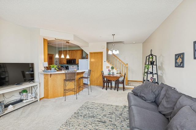 8829 Branson Dr Unit 46, Inver Grove Heights, MN 55076 - living room with a chandelier, light carpet, stairs, and a textured ceiling