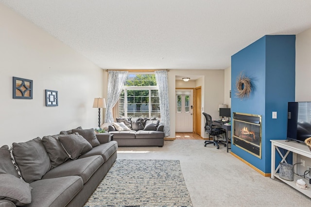 8829 Branson Dr Unit 46, Inver Grove Heights, MN 55076 - living room featuring a glass covered fireplace, a textured ceiling, and carpet flooring
