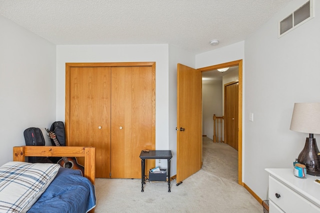 8829 Branson Dr Unit 46, Inver Grove Heights, MN 55076 - bedroom featuring light carpet, a closet, and a textured ceiling