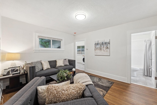 4714 Aldrich Ave N, Minneapolis, MN 55430 - living room with a textured ceiling, wood finished floors, and washer / dryer