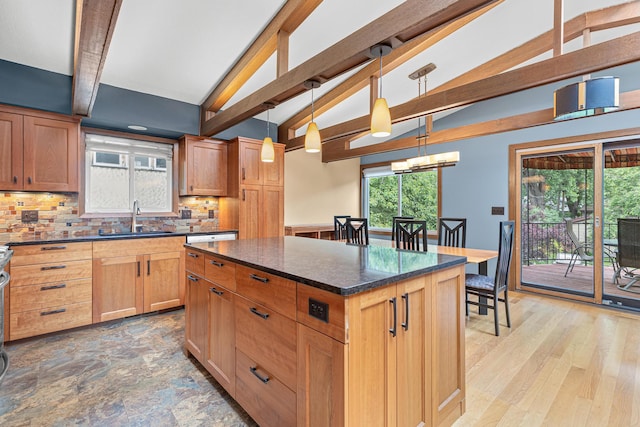1803 Hubbard Ave, Saint Paul, MN 55104 - kitchen featuring beam ceiling, decorative backsplash, a kitchen island, pendant lighting, and dark stone countertops