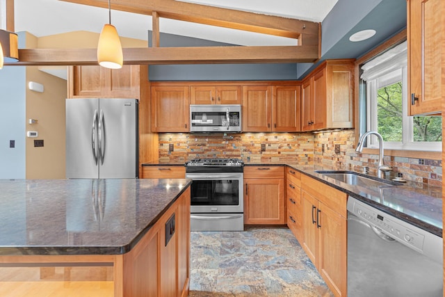 1803 Hubbard Ave, Saint Paul, MN 55104 - kitchen featuring appliances with stainless steel finishes, vaulted ceiling, dark stone counters, backsplash, and decorative light fixtures