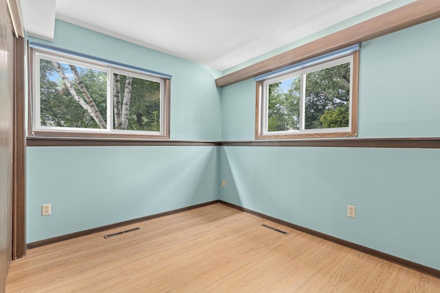 1803 Hubbard Ave, Saint Paul, MN 55104 - empty room with healthy amount of natural light and wood finished floors