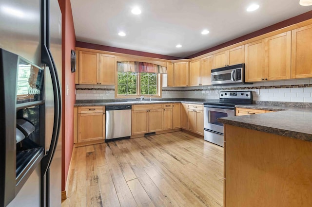 7270 Stone Rdg, Crow Wing Twp, MN 56401 - kitchen featuring stainless steel appliances, light wood-type flooring, dark countertops, tasteful backsplash, and plenty of natural light