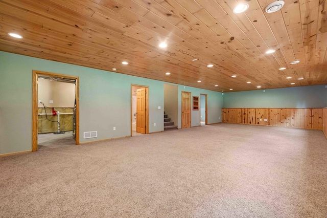 7270 Stone Rdg, Crow Wing Twp, MN 56401 - below grade area featuring recessed lighting, stairs, wood ceiling, wooden walls, and carpet floors