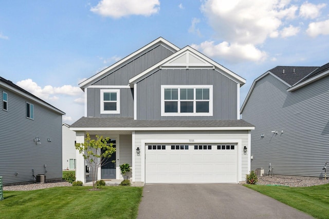9266 26th St NE, Saint Michael, MN 55376 - craftsman house with asphalt driveway, an attached garage, a front yard, and board and batten siding
