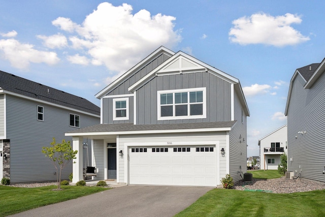 9266 26th St NE, Saint Michael, MN 55376 - view of front of property featuring board and batten siding, driveway, an attached garage, and a front lawn