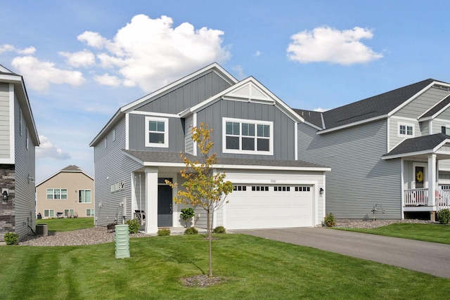 9266 26th St NE, Saint Michael, MN 55376 - view of front of property with board and batten siding, driveway, a garage, and a front yard
