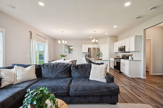 9266 26th St NE, Saint Michael, MN 55376 - living area with a chandelier, dark wood-style flooring, recessed lighting, and a textured ceiling