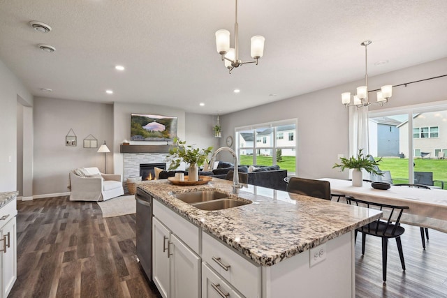 9266 26th St NE, Saint Michael, MN 55376 - kitchen featuring a chandelier, open floor plan, dark wood-style flooring, stainless steel dishwasher, and a fireplace