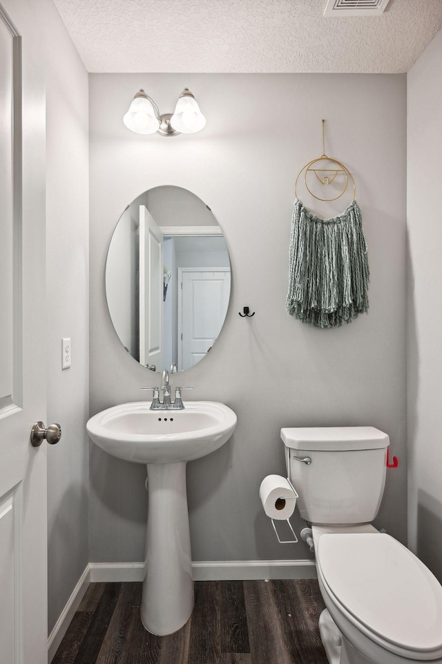 9266 26th St NE, Saint Michael, MN 55376 - half bathroom with wood finished floors and a textured ceiling
