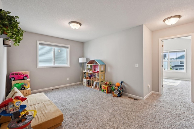 9266 26th St NE, Saint Michael, MN 55376 - game room featuring carpet flooring and a textured ceiling