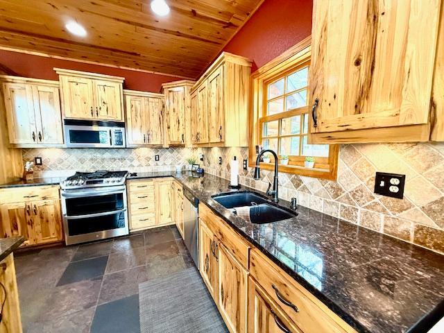 49512 202nd Pl, Shamrock Twp, MN 55760 - kitchen with appliances with stainless steel finishes, dark stone countertops, tasteful backsplash, wood ceiling, and vaulted ceiling