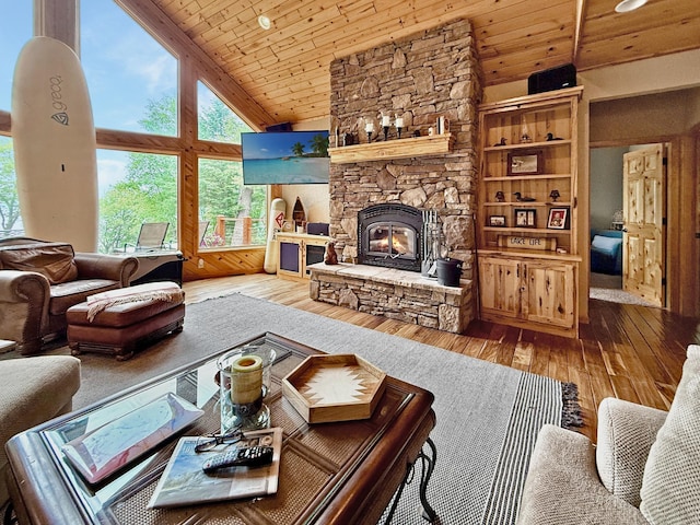 49512 202nd Pl, Shamrock Twp, MN 55760 - living area featuring wooden ceiling, healthy amount of natural light, hardwood / wood-style flooring, high vaulted ceiling, and a fireplace