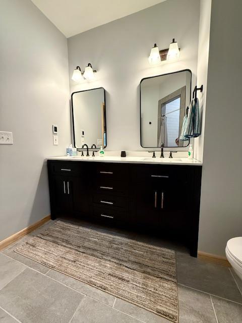 49512 202nd Pl, Shamrock Twp, MN 55760 - bathroom featuring double vanity and tile patterned floors
