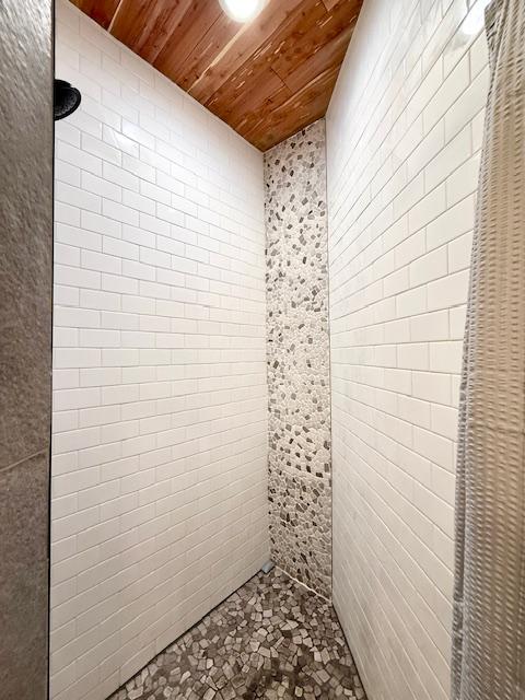 49512 202nd Pl, Shamrock Twp, MN 55760 - bathroom with wood ceiling and a tile shower