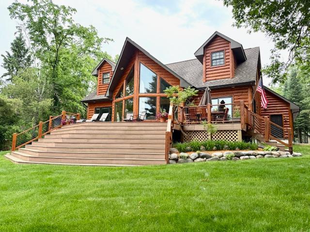 49512 202nd Pl, Shamrock Twp, MN 55760 - rear view of property featuring a lawn, a deck, and roof with shingles