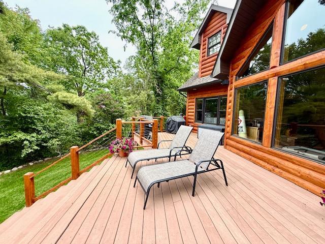 49512 202nd Pl, Shamrock Twp, MN 55760 - wooden terrace with view of wooded area