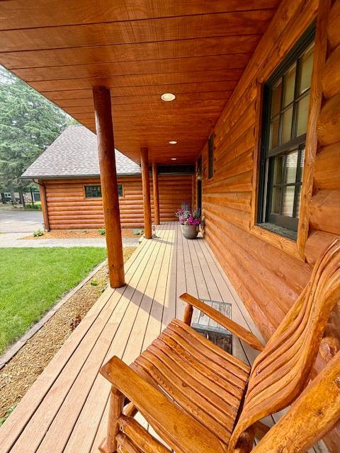 49512 202nd Pl, Shamrock Twp, MN 55760 - wooden porch with a lawn