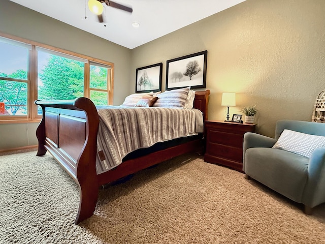 49512 202nd Pl, Shamrock Twp, MN 55760 - bedroom featuring carpet floors, multiple windows, a textured wall, and ceiling fan