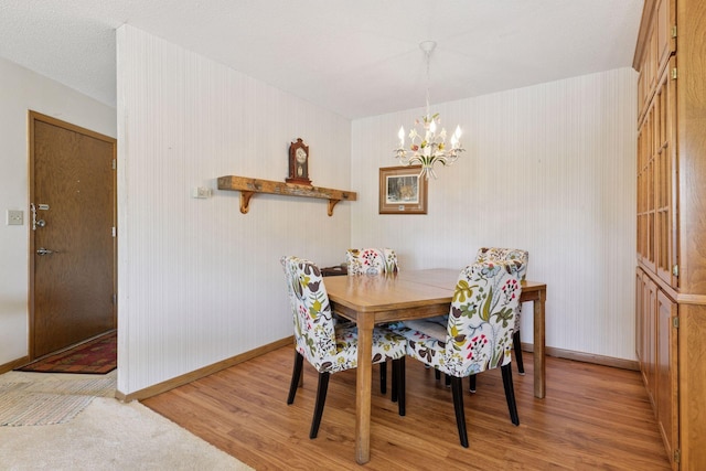 5440 Three Points Blvd Unit 531, Mound, MN 55364 - dining space featuring light wood finished floors and a chandelier