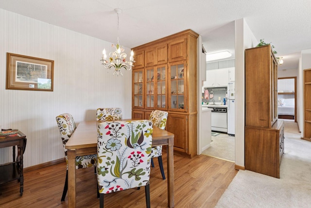 5440 Three Points Blvd Unit 531, Mound, MN 55364 - dining space with light wood-style floors and a chandelier