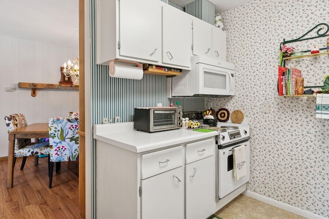 5440 Three Points Blvd Unit 531, Mound, MN 55364 - kitchen with white appliances, light countertops, white cabinets, light wood-style flooring, and a chandelier