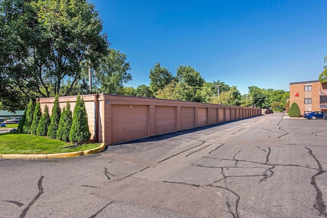 5440 Three Points Blvd Unit 531, Mound, MN 55364 - view of asphalt road featuring community garages