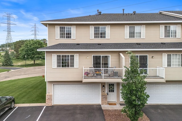 2533 Cobble Hill Ct Unit H, Woodbury, MN 55125 - view of property with a front lawn, asphalt driveway, a balcony, a garage, and brick siding