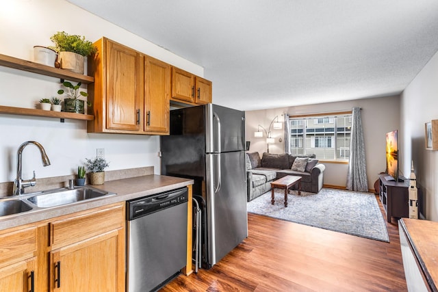 2533 Cobble Hill Ct Unit H, Woodbury, MN 55125 - kitchen with appliances with stainless steel finishes, open floor plan, light wood-style floors, open shelves, and light countertops