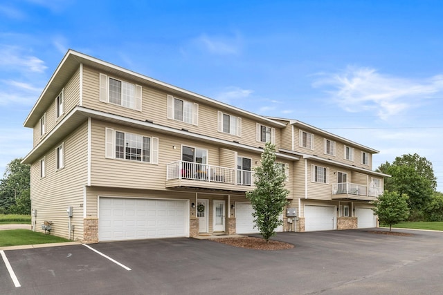 2533 Cobble Hill Ct Unit H, Woodbury, MN 55125 - view of front of property featuring a garage, driveway, and brick siding