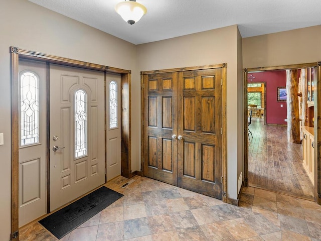 2406 Augusta Rd, Fair Haven Twp, MN 55382 - entrance foyer with healthy amount of natural light and light stone finish floors