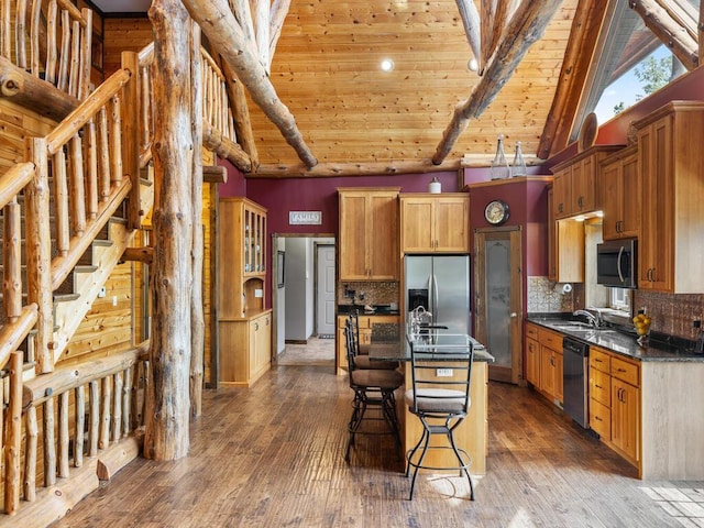 2406 Augusta Rd, Fair Haven Twp, MN 55382 - kitchen with stainless steel appliances, dark countertops, a kitchen breakfast bar, dark wood-type flooring, and a wood ceiling with exposed beams